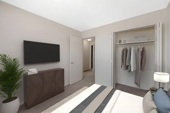 Bedroom with organized closet and flat screen tv